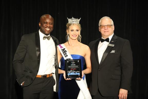 Mayor Yemi Mobolade and Colorado Springs City Councilmembers President Randy Helms present Madison Marsh with the Spirit of the Springs award