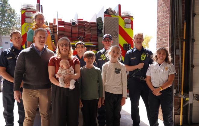 Chelsie, her baby and family take a picture with the Colorado Springs Fire Department